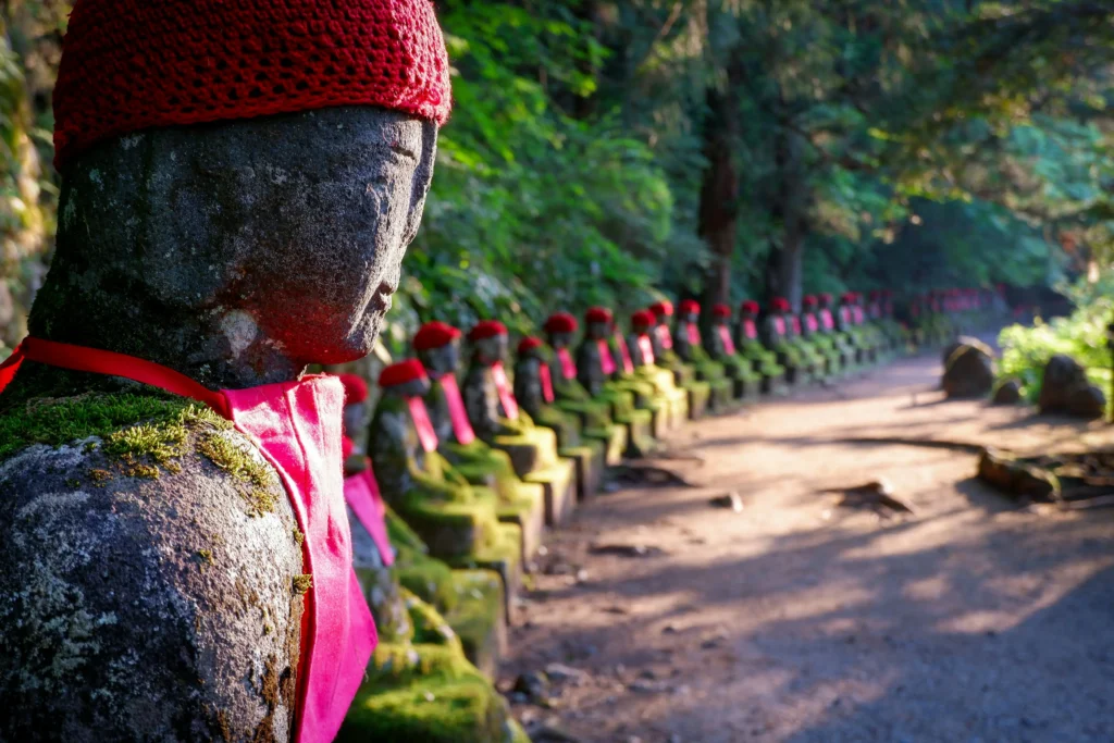 Row of stone figures wearing knitted hats and aprons