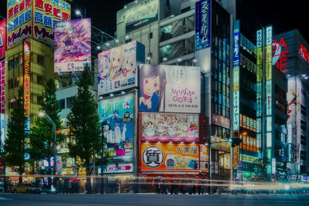Tokyo street illuminated by colorful anime billboards and bright signs